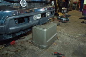 A plastic storage bin makes a good support for the loose bumper.